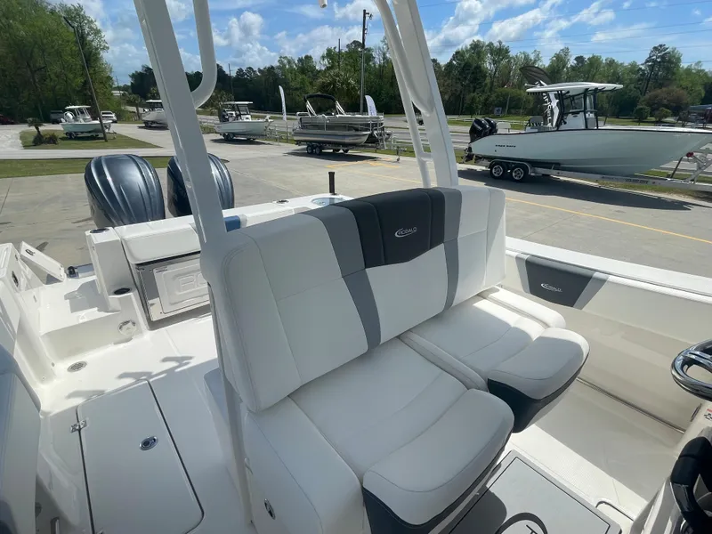 Slide: The Image of 2023 Robalo 270 boat with dual engines and white cushioned seating. - 15
