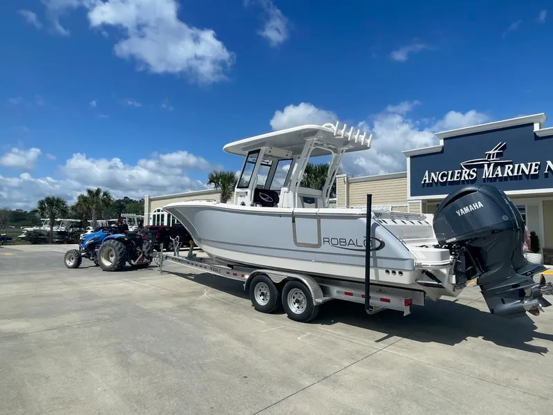 Slide: The Image of 2023 Robalo 270 boat on trailer at Anglers Marine dealership. - 2