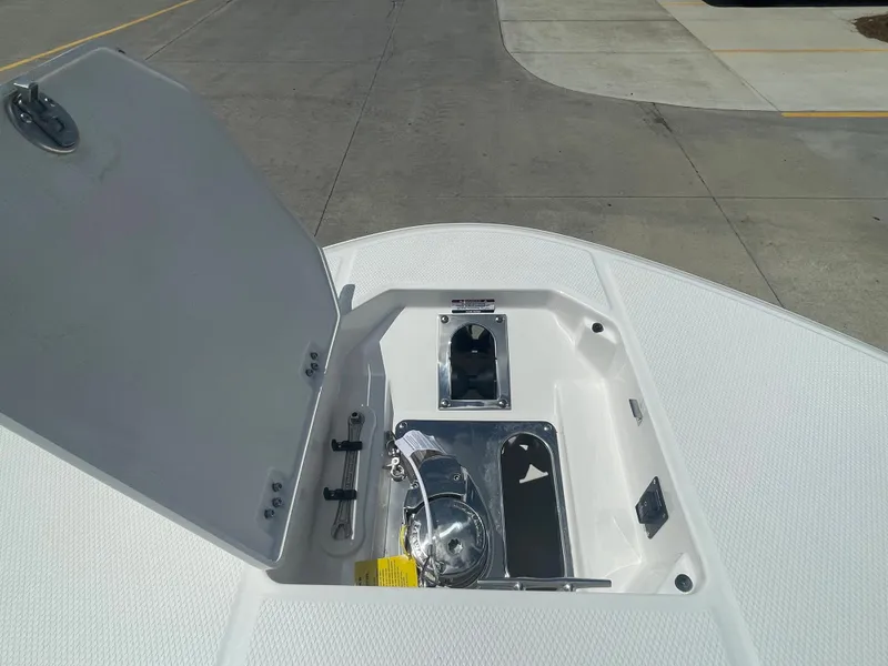 Slide: The Image of 2023 Robalo 270 boat anchor storage compartment with open hatch. - 23