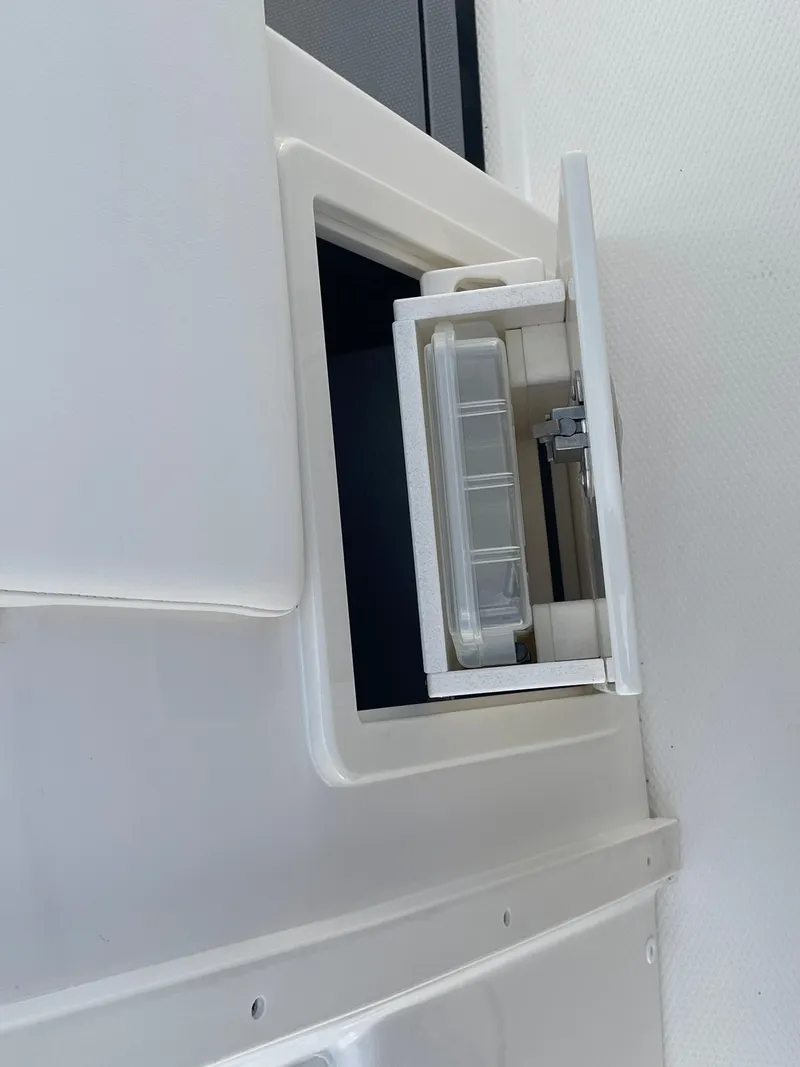 Slide: The Image of Built-in storage compartment on a 2023 Robalo 270 boat. - 28
