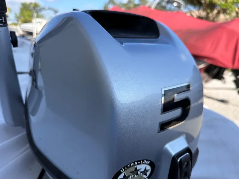 Slide: The Image of Close-up of a 2020 Bris 10' Ribbed boat engine with a 5 marking. - 4