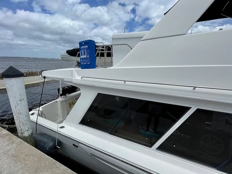 Slide: The Image of 2004 Meridian 490 Pilothouse yacht docked at marina under cloudy sky. - 11