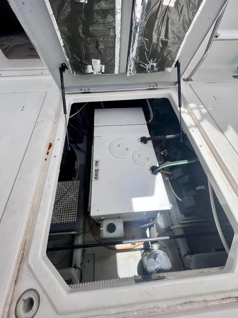 Slide: The Image of Engine compartment of 2004 Meridian 490 Pilothouse boat, showing mechanical components. - 17