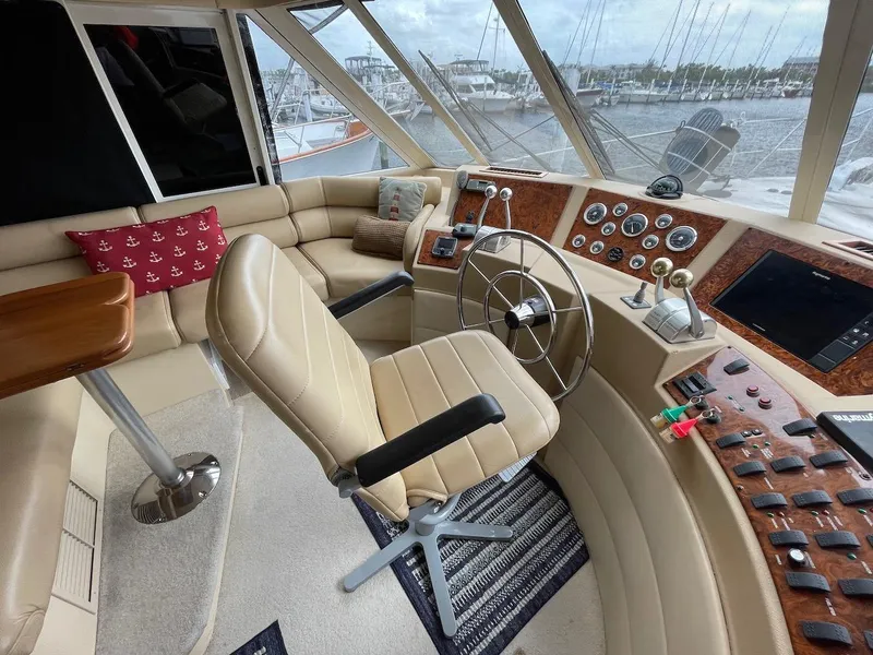 Slide: The Image of Luxurious 2004 Meridian 490 Pilothouse interior with helm, leather seating, and panoramic windows. - 21