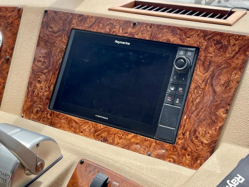 Slide: The Image of Raymarine navigation display on 2004 Meridian 490 Pilothouse dashboard with wood paneling. - 22
