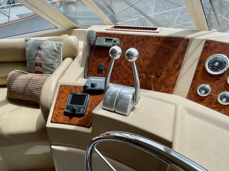 Slide: The Image of 2004 Meridian 490 Pilothouse helm with wood accents and navigation controls. - 23
