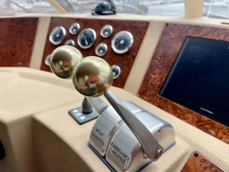 Slide: The Image of Meridian 490 Pilothouse 2004 helm with throttle controls and instrument panel. - 25