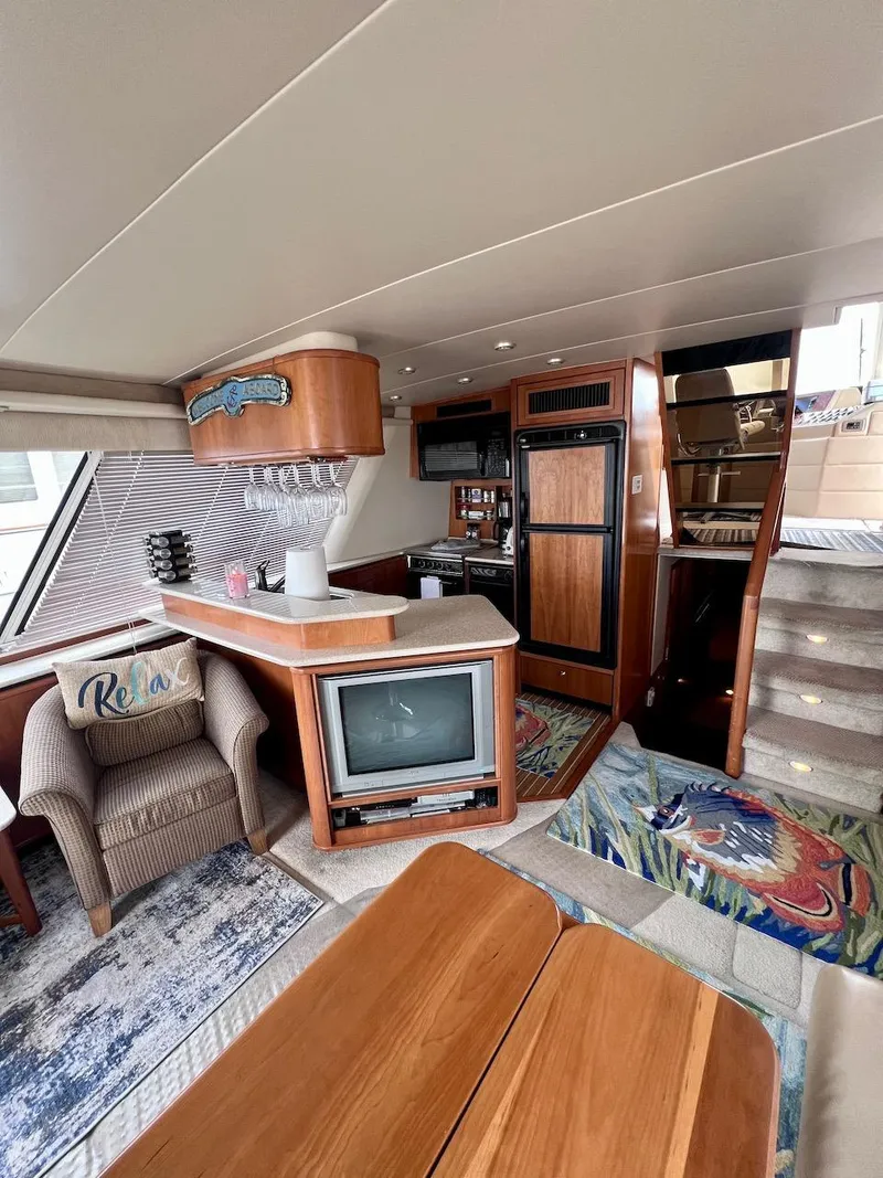 Slide: The Image of Interior of 2004 Meridian 490 Pilothouse yacht with cozy seating and modern amenities. - 31