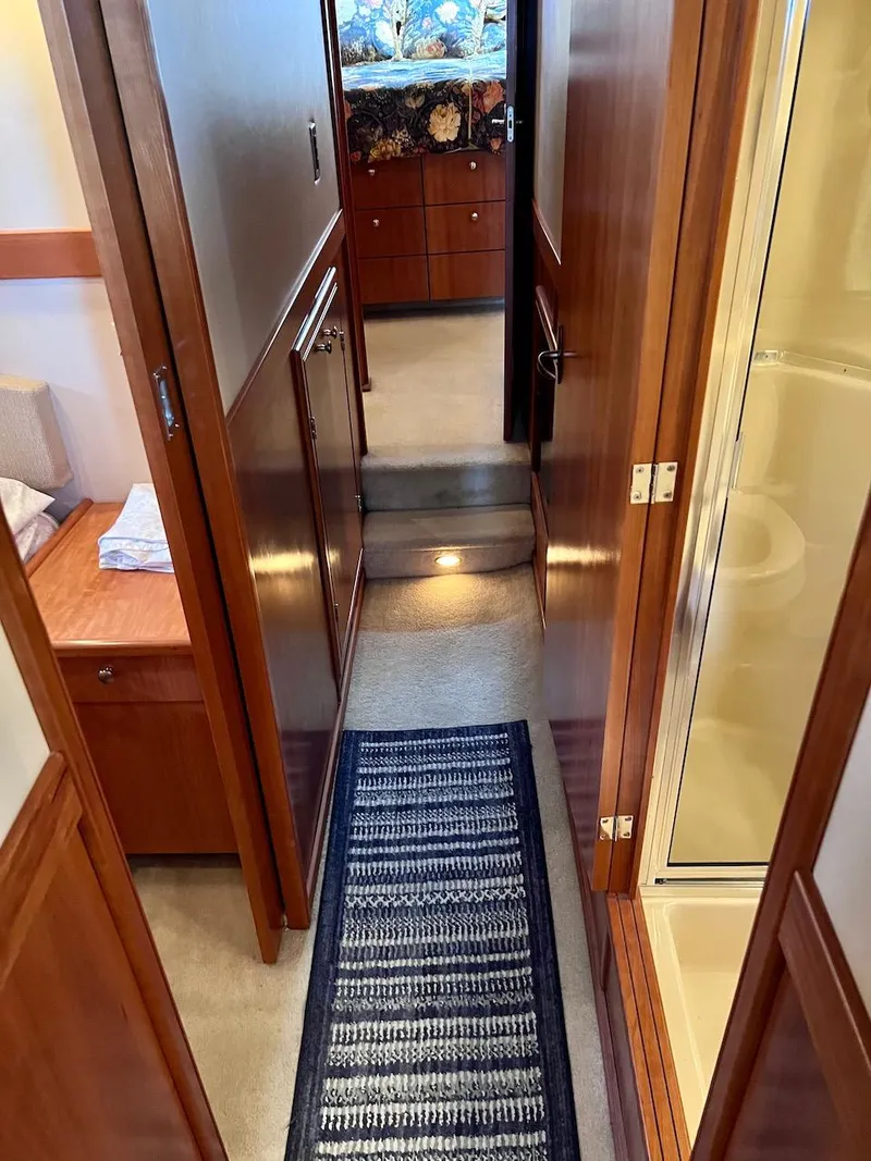 Slide: The Image of Interior hallway of 2004 Meridian 490 Pilothouse yacht with wood paneling and carpet runner. - 37
