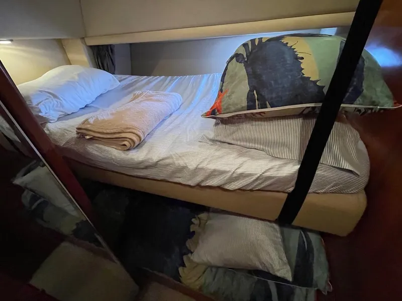 Slide: The Image of Cozy bedroom in 2004 Meridian 490 Pilothouse yacht with striped bedding and pillows. - 41