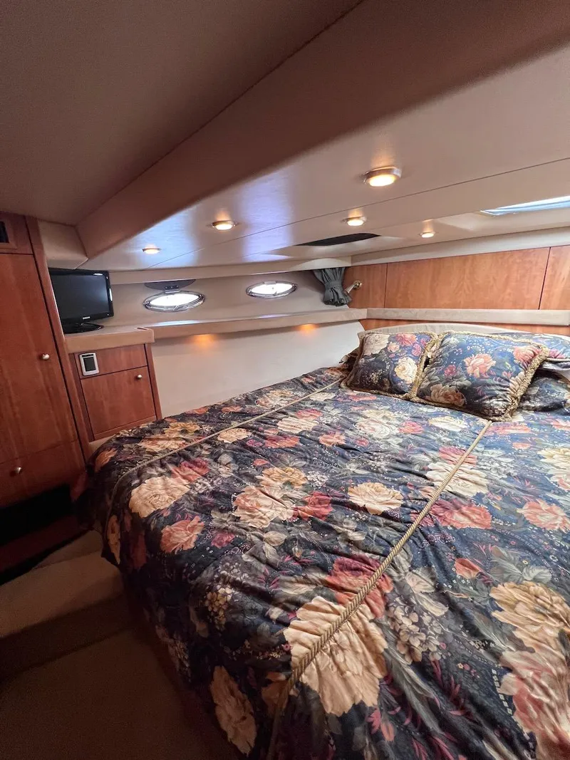 Slide: The Image of Luxurious bedroom in 2004 Meridian 490 Pilothouse yacht with floral bedding and wood accents. - 43