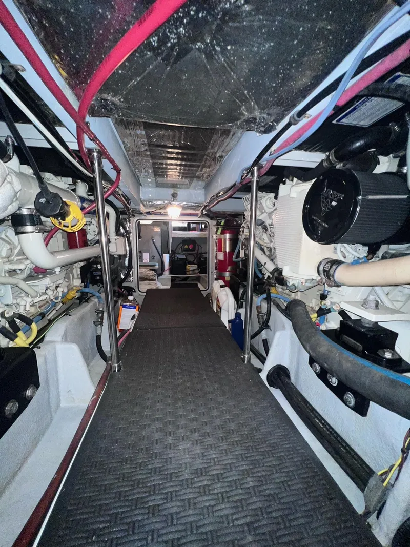 Slide: The Image of Engine room of a 2004 Meridian 490 Pilothouse yacht with visible machinery and wiring. - 48