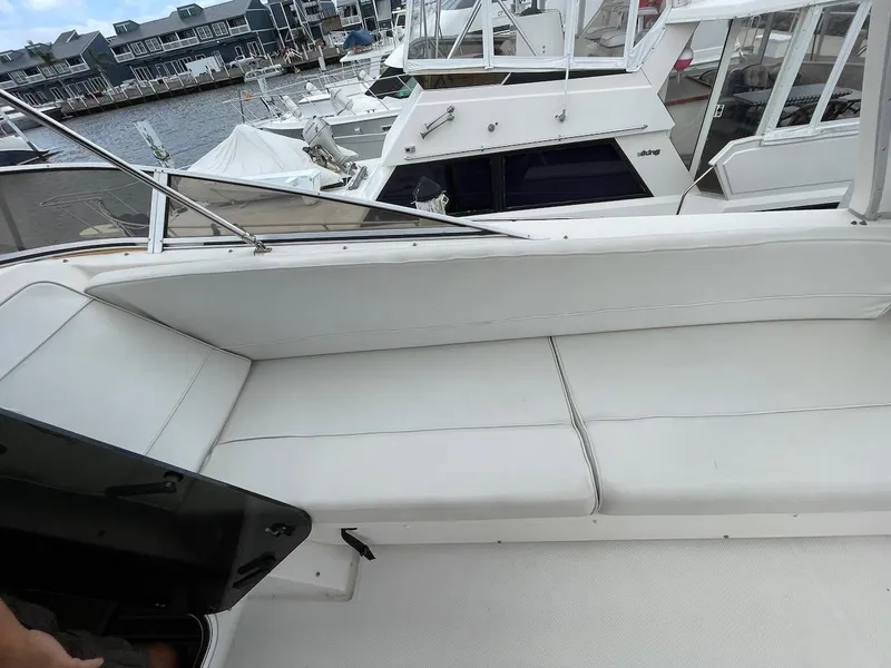 Slide: The Image of 2004 Meridian 490 Pilothouse yacht with white seating, docked at a marina. - 6