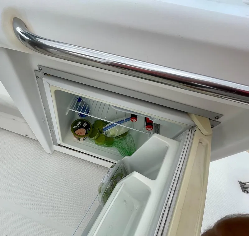 Slide: The Image of Open mini fridge on 2004 Meridian 490 Pilothouse boat, stocked with drinks and snacks. - 7