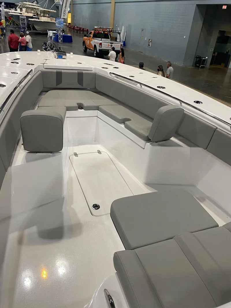 Slide: The Image of 2022 Cape Horn 34 XS boat interior with gray seating at a boat show. - 9