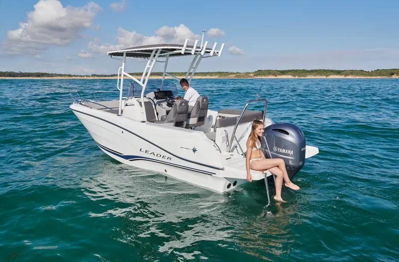 Slide: The Image of 2023 Jeanneau Leader 6.5 CC S3 boat on water with people enjoying. - 2