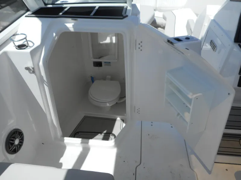 Slide: The Image of 2023 Sea Fox 268 Traveler boat interior with a compact marine toilet. - 13