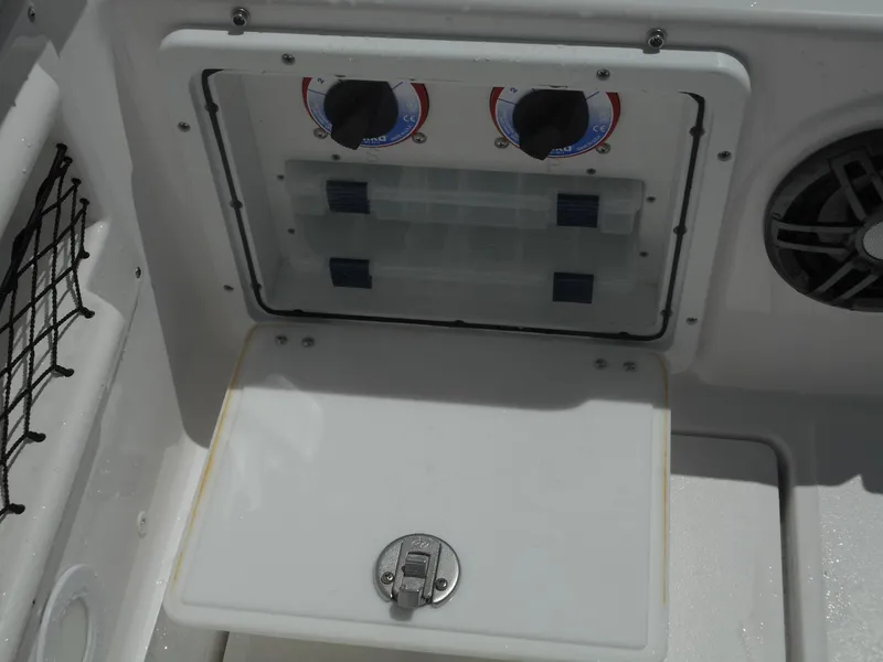 Slide: The Image of Control panel and storage compartment on a 2023 Sea Fox 268 Traveler boat. - 26