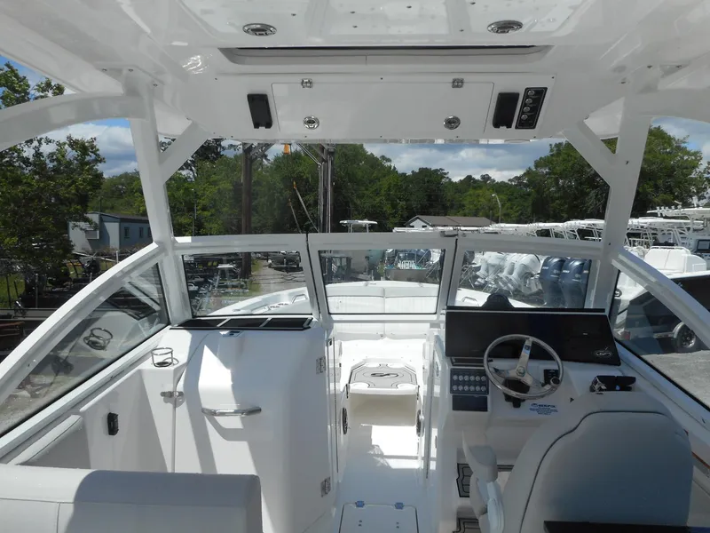 Slide: The Image of 2023 Sea Fox 268 Traveler boat interior with helm and seating area. - 5