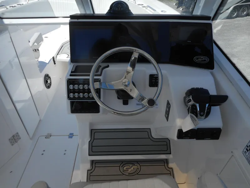 Slide: The Image of 2023 Sea Fox 268 Traveler boat helm with steering wheel and control panel. - 6