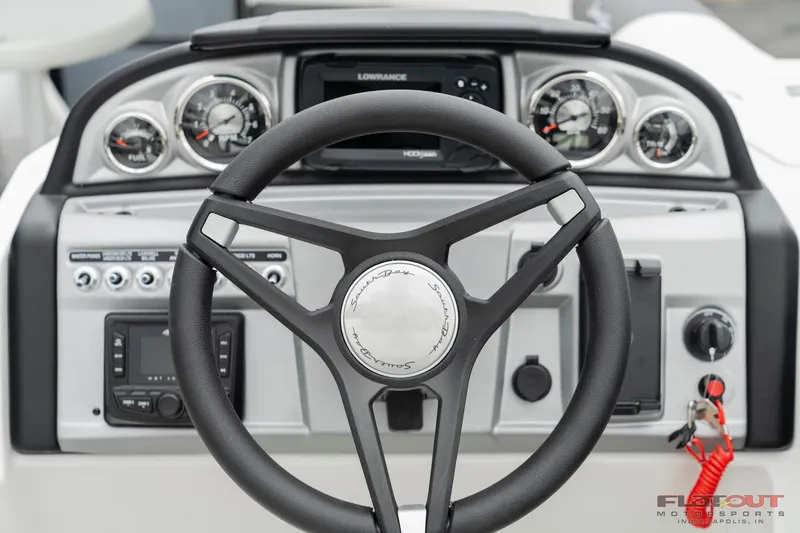 Slide: The Image of 2023 South Bay S224 Universal Lounge 200HP boat dashboard and steering wheel. - 10