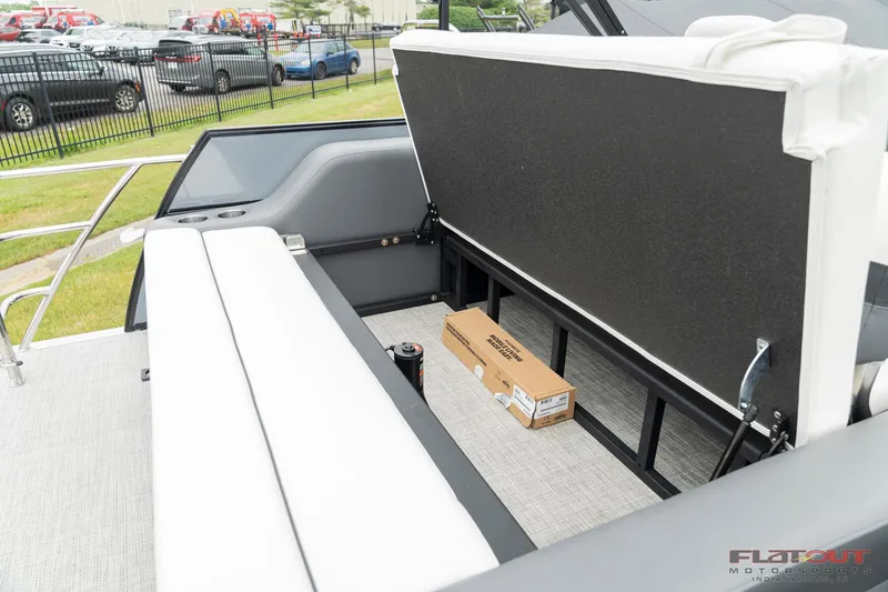 Slide: The Image of 2023 South Bay S224 Universal Lounge 200HP boat with open storage compartment. - 2