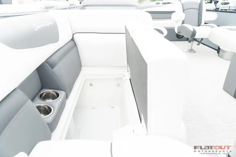 Slide: The Image of 2023 South Bay S224 Universal Lounge 200HP interior with storage compartment and cup holders. - 20