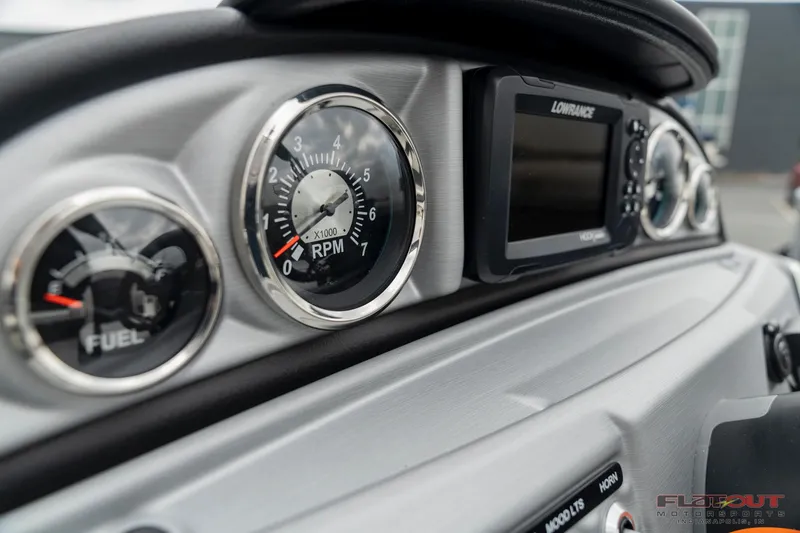 Slide: The Image of Close-up of 2023 South Bay S224 Universal Lounge 200HP dashboard with gauges and Lowrance display. - 6