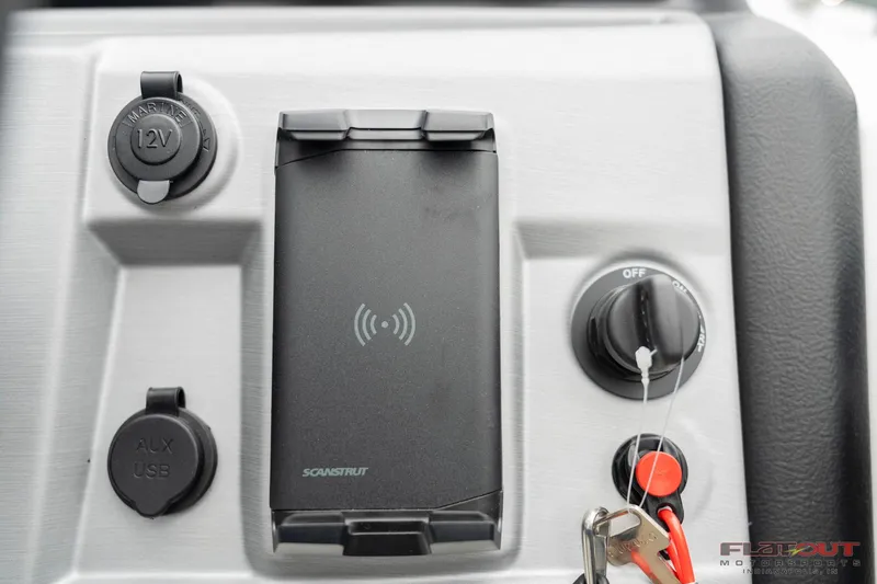 Slide: The Image of Control panel of 2023 South Bay S224 Universal Lounge 200HP boat with key ignition and charging ports. - 8