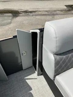 Slide: The Image of 2023 Vanderbilt 700T boat interior with open storage compartment and cushioned seating. - 15