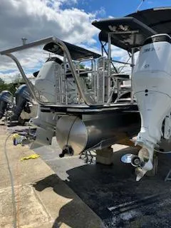 Slide: The Image of 2023 Vanderbilt 700T boat with dual outboard motors on a sunny day. - 24