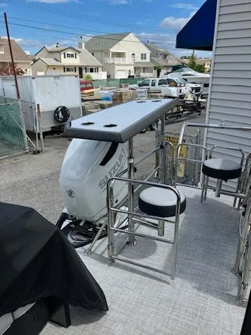 Slide: The Image of 2023 Vanderbilt 700T boat with Suzuki outboard motor in a residential area. - 7