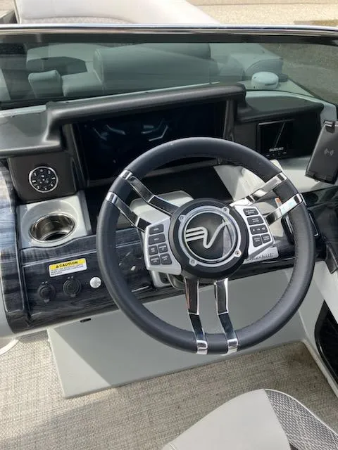 Slide: The Image of Steering wheel and dashboard of a 2023 Vanderbilt 700T boat. - 9
