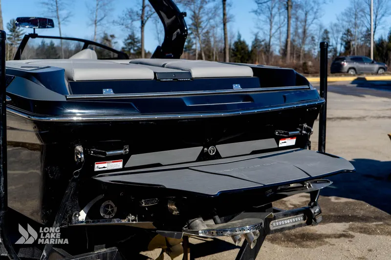 Slide: The Image of 2022 Centurion Fi23 boat rear view at Long Lake Marina, showcasing swim platform. - 12