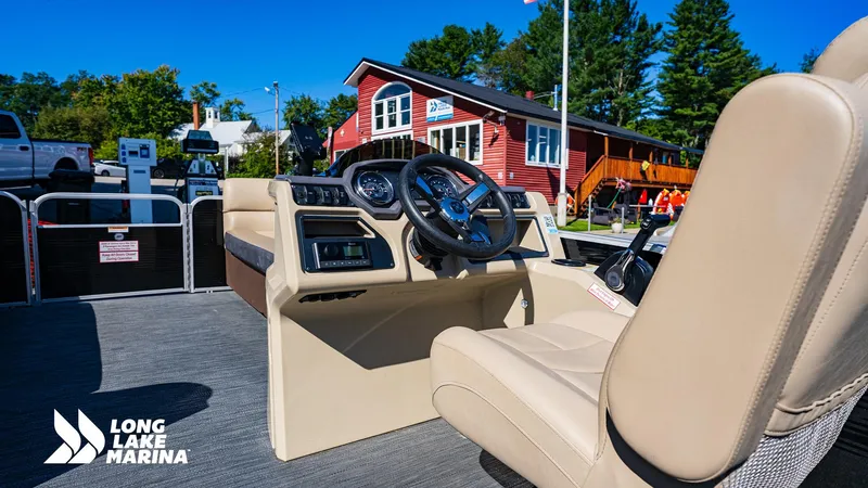 Slide: The Image of 2023 Godfrey Sw2286SB boat interior at Long Lake Marina, featuring steering console and seating. - 10