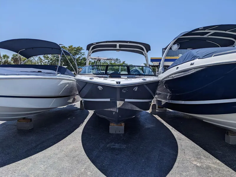 Slide: The Image of 2023 Four Winns H2 boat displayed between two other boats. - 1