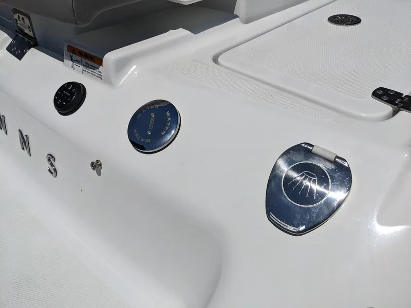 Slide: The Image of 2023 Four Winns H2 boat deck with fuel cap and storage compartments. - 10