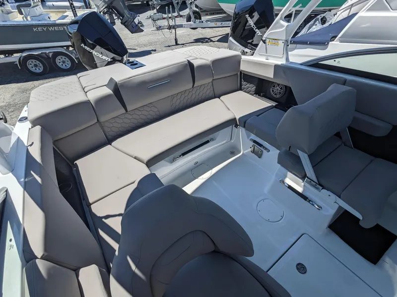 Slide: The Image of 2023 Four Winns H2 boat interior with gray seating and white deck. - 11