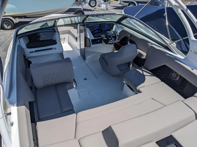 Slide: The Image of 2023 Four Winns H2 boat interior with modern seating and steering console. - 12