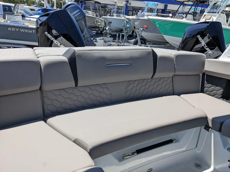 Slide: The Image of 2023 Four Winns H2 boat interior with cushioned seating and Mercury outboard motors. - 13