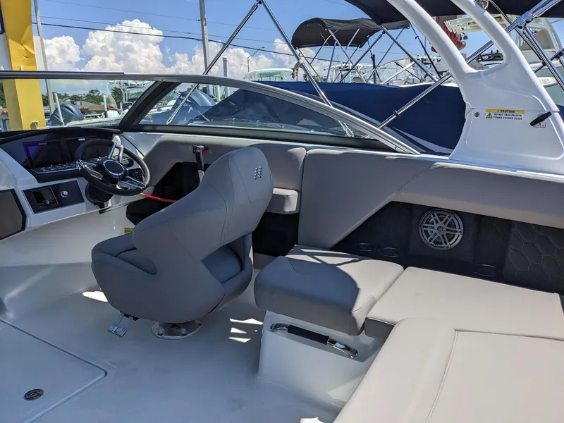 Slide: The Image of 2023 Four Winns H2 boat interior with gray seating and modern dashboard. - 15