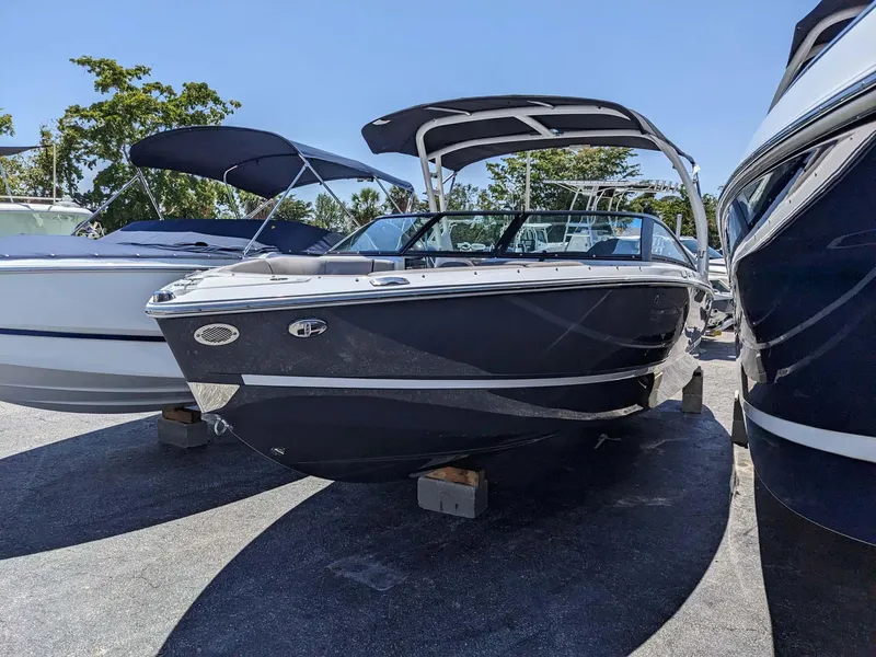 Slide: The Image of 2023 Four Winns H2 boat on display in a marina. - 2