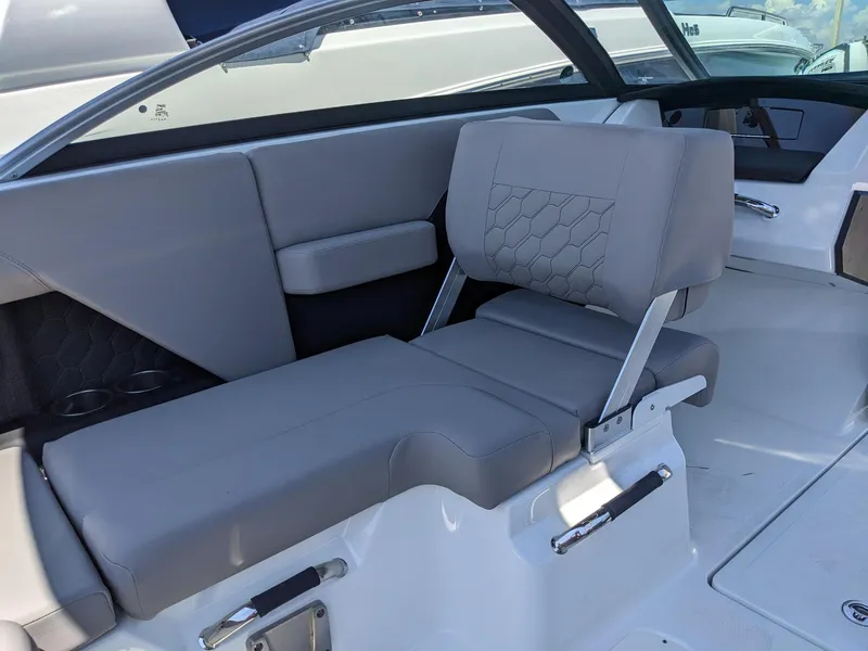 Slide: The Image of 2023 Four Winns H2 boat interior with gray seating and modern design. - 23