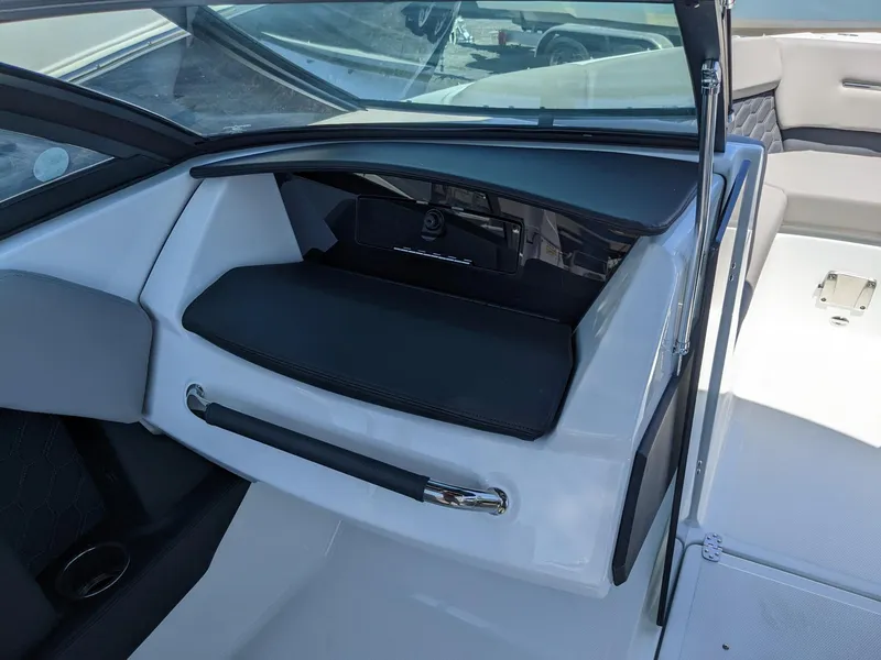 Slide: The Image of 2023 Four Winns H2 boat interior with storage compartment and seating area. - 24