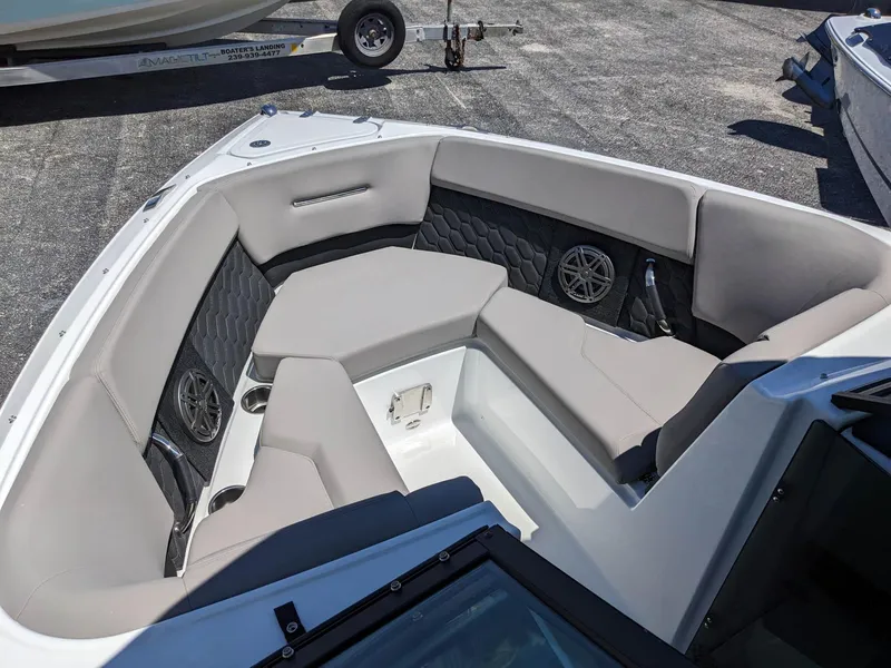 Slide: The Image of 2023 Four Winns H2 boat interior with gray seating and built-in speakers. - 25