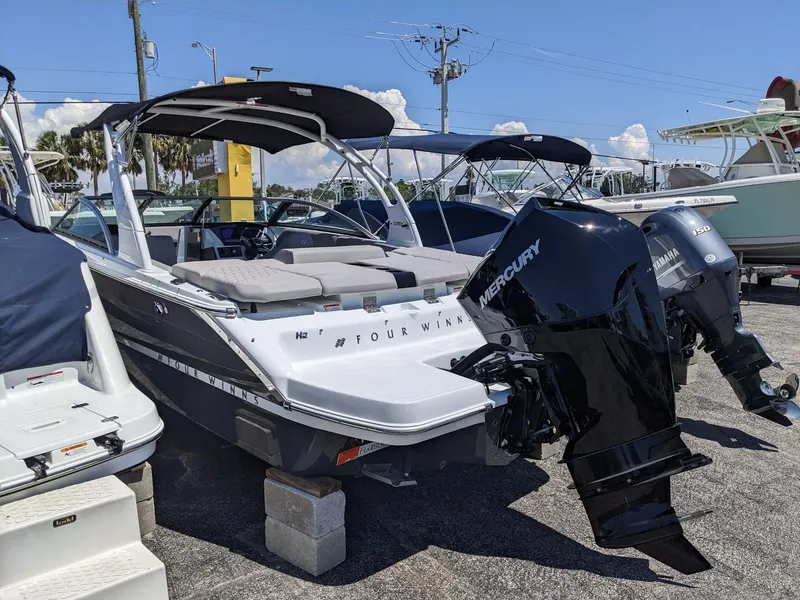 Slide: The Image of 2023 Four Winns H2 boat with Mercury outboard engine on display. - 3
