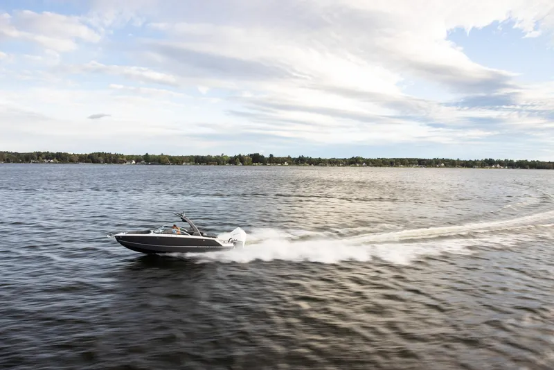 Slide: The Image of 2023 Four Winns H2 speedboat cruising on a lake under a partly cloudy sky. - 39