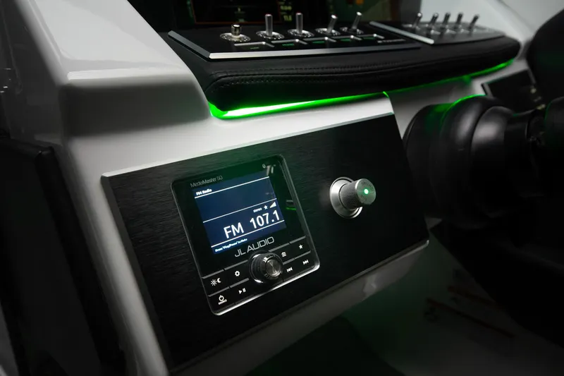 Slide: The Image of 2023 Four Winns H2 boat dashboard with JL Audio system and green LED lighting. - 49