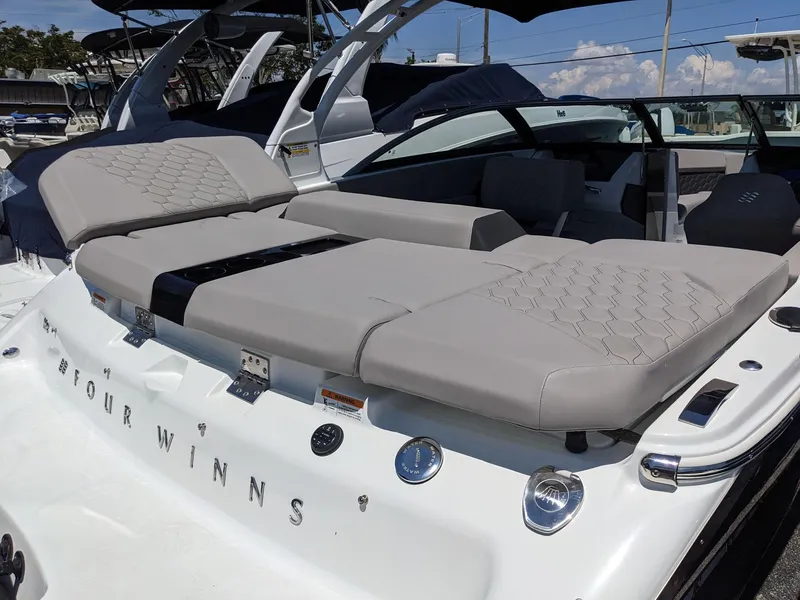 Slide: The Image of 2023 Four Winns H2 boat with luxurious seating and sleek design. - 8