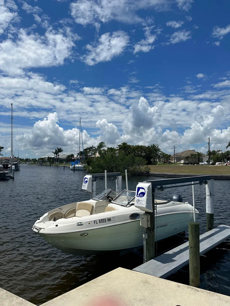 Slide: The Image of 2018 Stingray 214 LR boat docked on a sunny day with blue skies. - 3